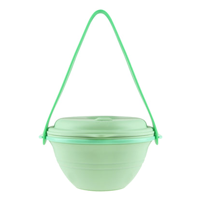 Green lunch box uncollapsed with the strap hooked onto it, front view.