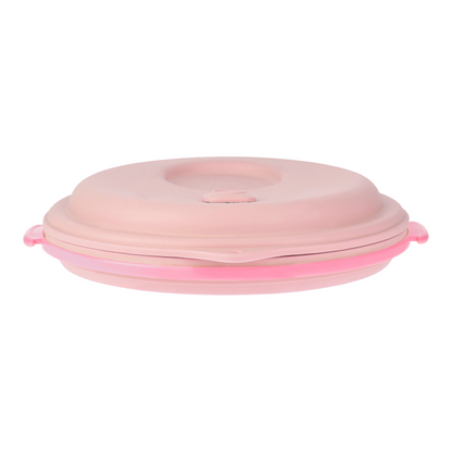 Pink lunch box collapsed with the strap inside, front view.